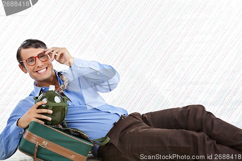 Image of Businessman Lying With Travel Bag