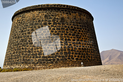 Image of hill lanzarote  spain the old wall castle  tower and door  in te