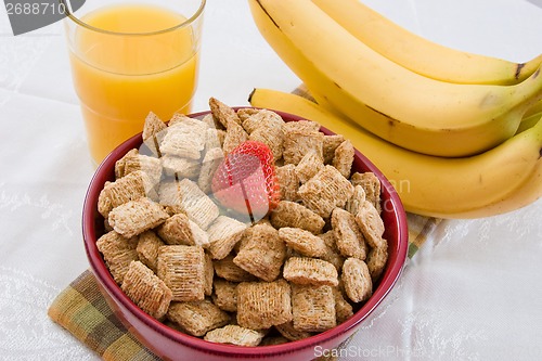 Image of Wheat Squares, Orange Juice and Bananas for Breakfast