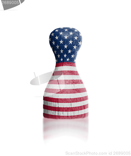 Image of Wooden pawn with a painting of a flag