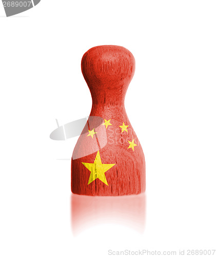 Image of Wooden pawn with a painting of a flag