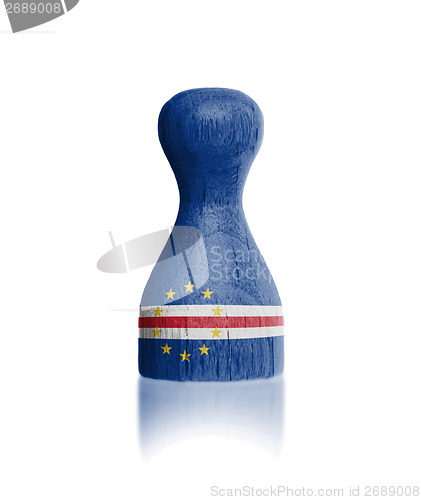 Image of Wooden pawn with a painting of a flag