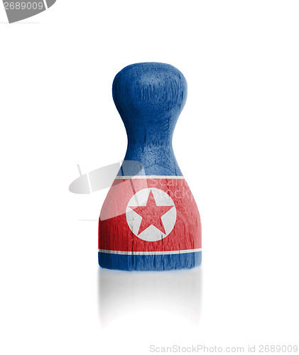 Image of Wooden pawn with a painting of a flag