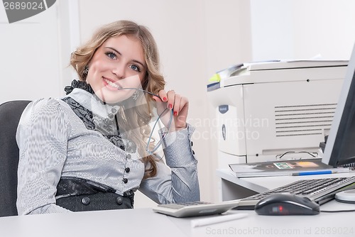 Image of Young attractive businesswoman in office