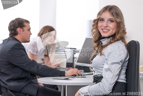 Image of Young business lady smiling in office