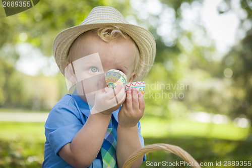 Image of Cute Little Boy Enjoying His Easter Eggs Outside in Park