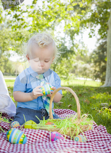 Image of Cute Little Boy Enjoying His Easter Eggs Outside in Park