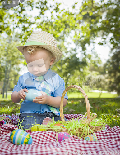 Image of Cute Little Boy Enjoying His Easter Eggs Outside in Park