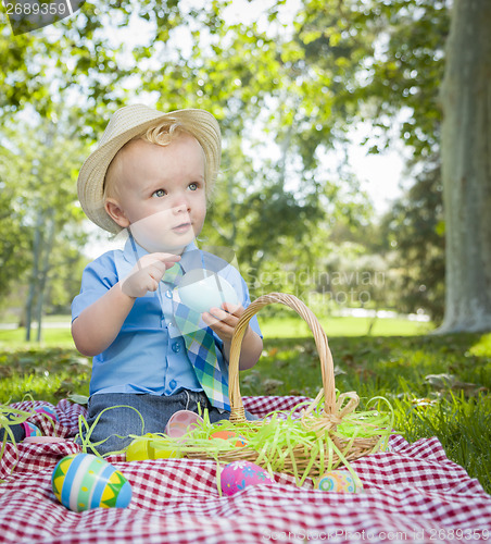 Image of Cute Little Boy Enjoying His Easter Eggs Outside in Park