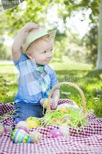 Image of Cute Little Boy Outside Holding Easter Eggs Tips His Hat