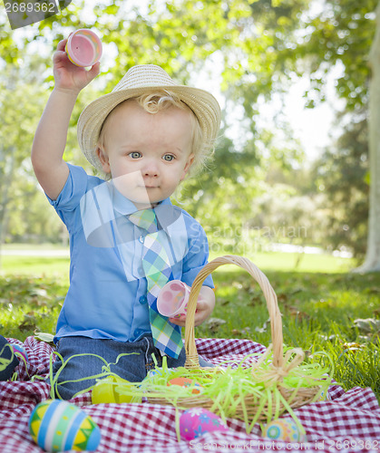 Image of Cute Little Boy Enjoying His Easter Eggs Outside in Park