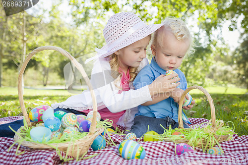 Image of Cute Young Brother and Sister Enjoying Their Easter Eggs Outside