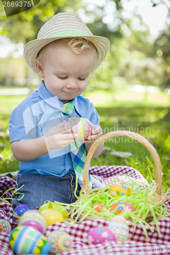 Image of Cute Little Boy Enjoying His Easter Eggs Outside in Park