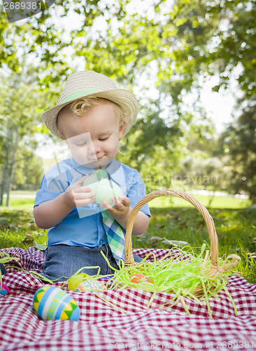 Image of Cute Little Boy Enjoying His Easter Eggs Outside in Park