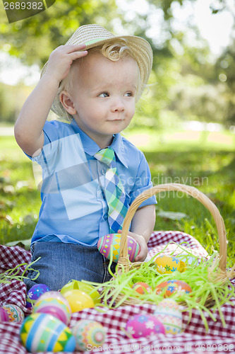 Image of Cute Little Boy Outside Holding Easter Eggs Tips His Hat