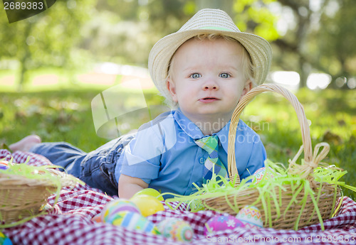 Image of Cute Little Boy Smiles With Easter Eggs Around Him