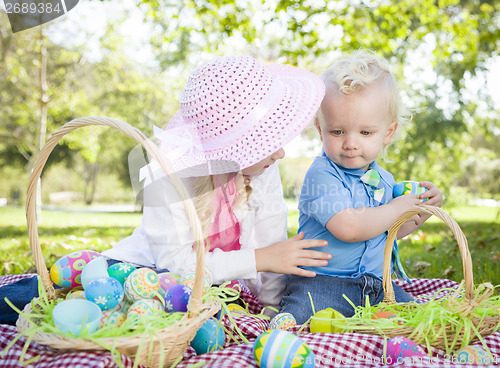 Image of Cute Young Brother and Sister Enjoying Their Easter Eggs Outside