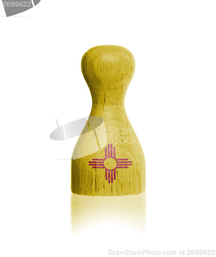 Image of Wooden pawn with a painting of a flag