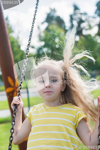 Image of Swinging little girl