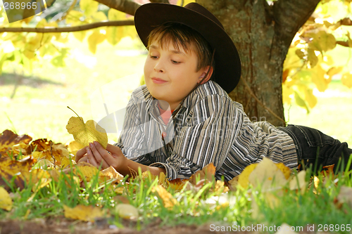 Image of Child holding autumn leaves
