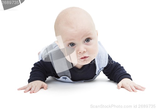 Image of baby crawling on white floor
