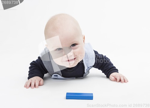 Image of interested baby with toy block
