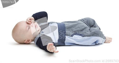 Image of tired baby on floor isolated on white