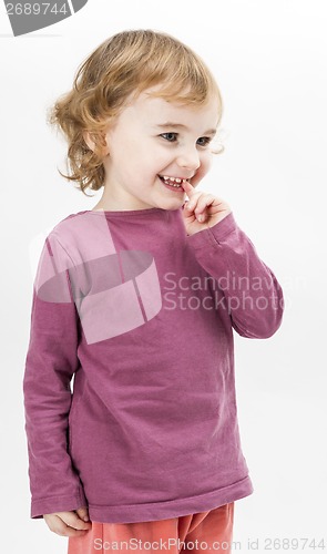 Image of abashed young girl in light grey background