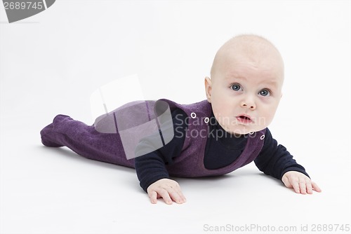 Image of toddler in dark clothing crawling