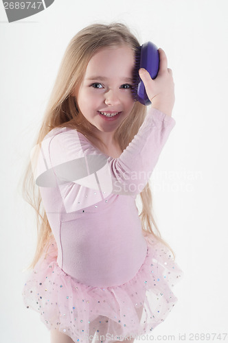 Image of Little girl combing hair