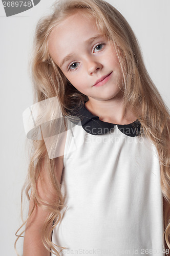Image of Little cute girl in white dress