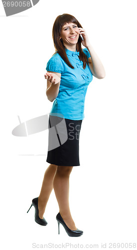 Image of Smiling attractive girl talking on the phone on the move on a wh
