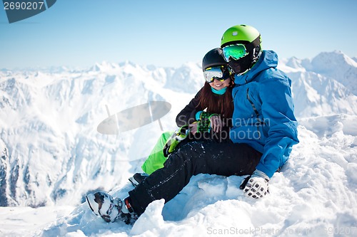 Image of Young happy couple in snowy mountains.