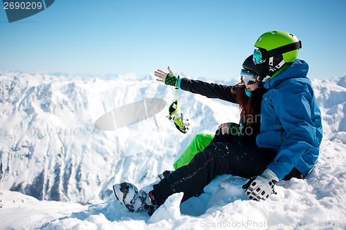 Image of Young happy couple in snowy mountains.