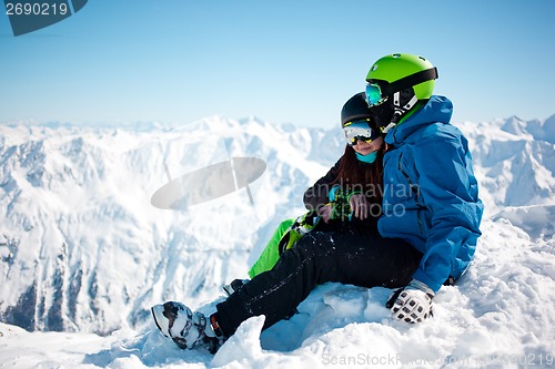 Image of Young happy couple in snowy mountains.