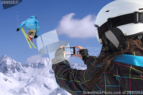 Image of Mobile phone photographs of skiers jump