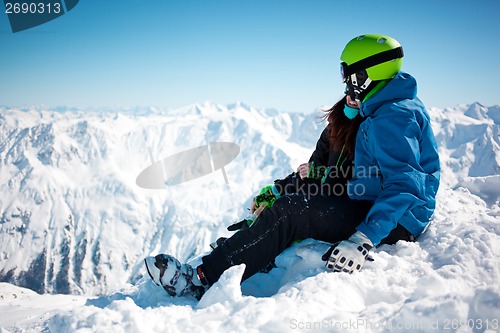 Image of Young happy couple in snowy mountains.