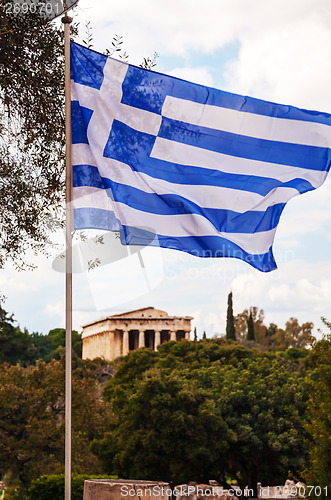 Image of Greek flag and Temple of Hephaestus in Athens, Greece