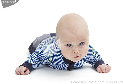 Image of attentive baby laying on ground