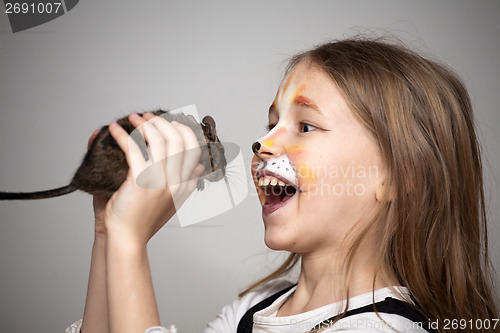 Image of girl painted as a cat with grey mouse in hands