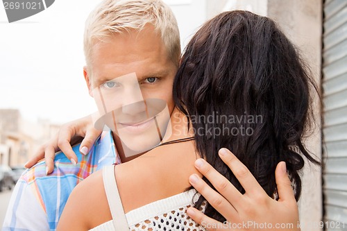 Image of Romantic handsome man hugging his girlfriend