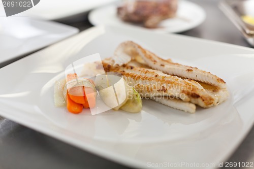 Image of Fried fish fillets and vegetables