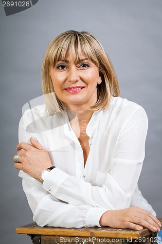 Image of Smiling confident middle-aged blond woman