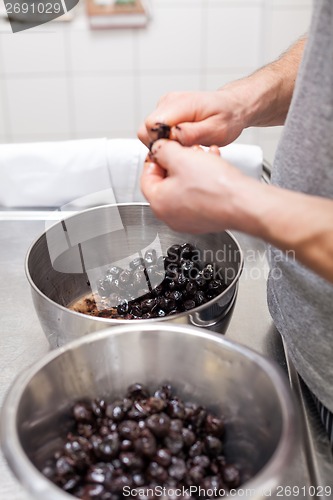 Image of Chef preparing ingredients in a commercial kitchen