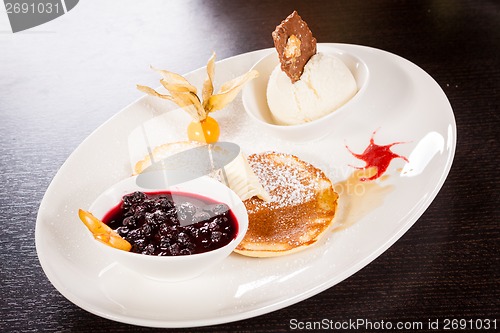 Image of tasty sweet pancakes with vanilla icecream and topping