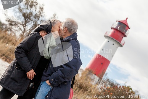 Image of happy mature couple relaxing baltic sea dunes 