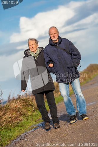 Image of happy mature couple relaxing baltic sea dunes 