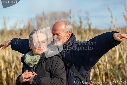 Image of Elderly couple embracing and celebrating the sun