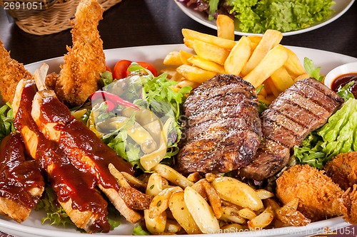 Image of Platter of mixed meats, salad and French fries