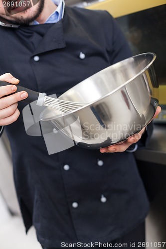 Image of Chef cooking a vegetables stir fry over a hob